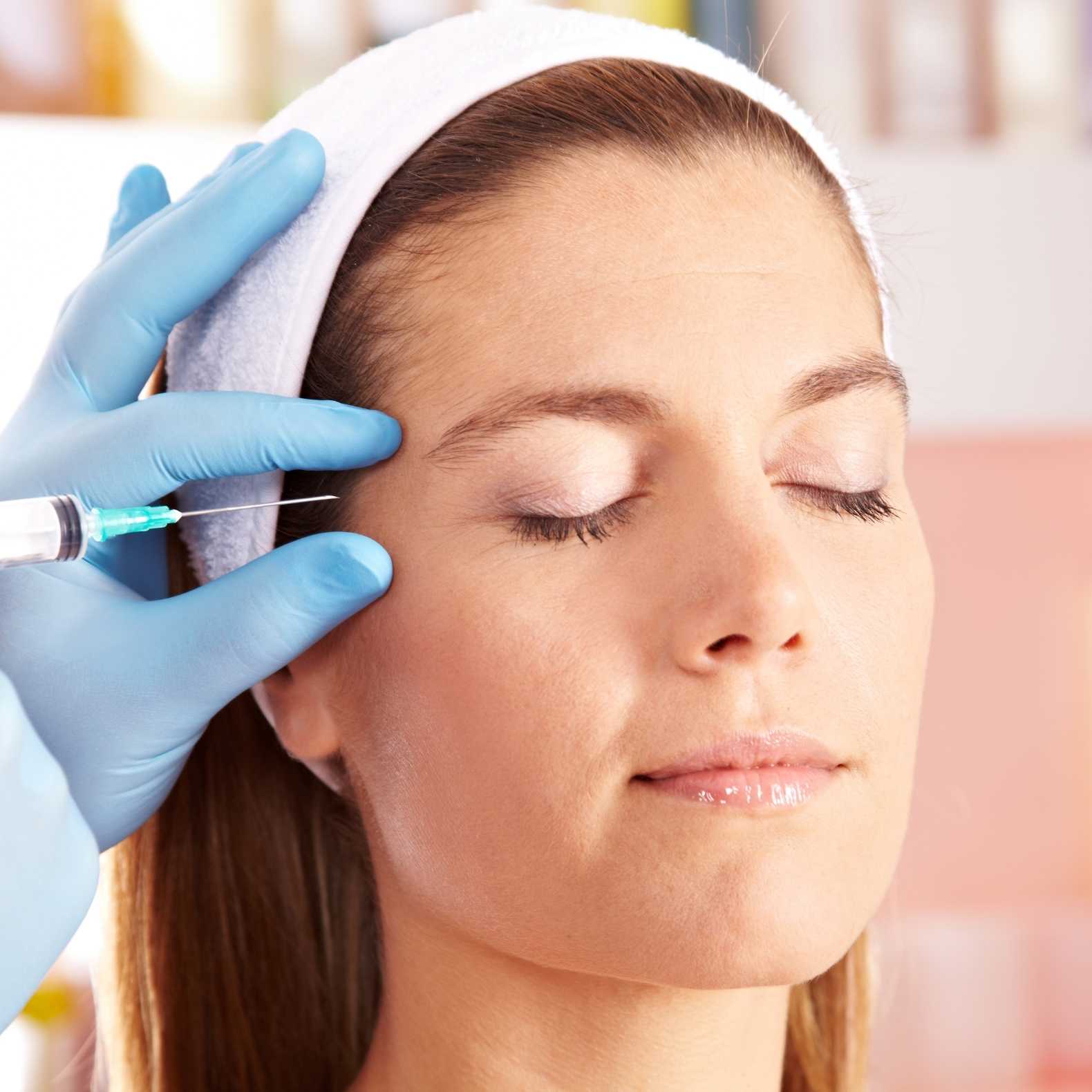 Botox treatment being administered to a patient's forehead.