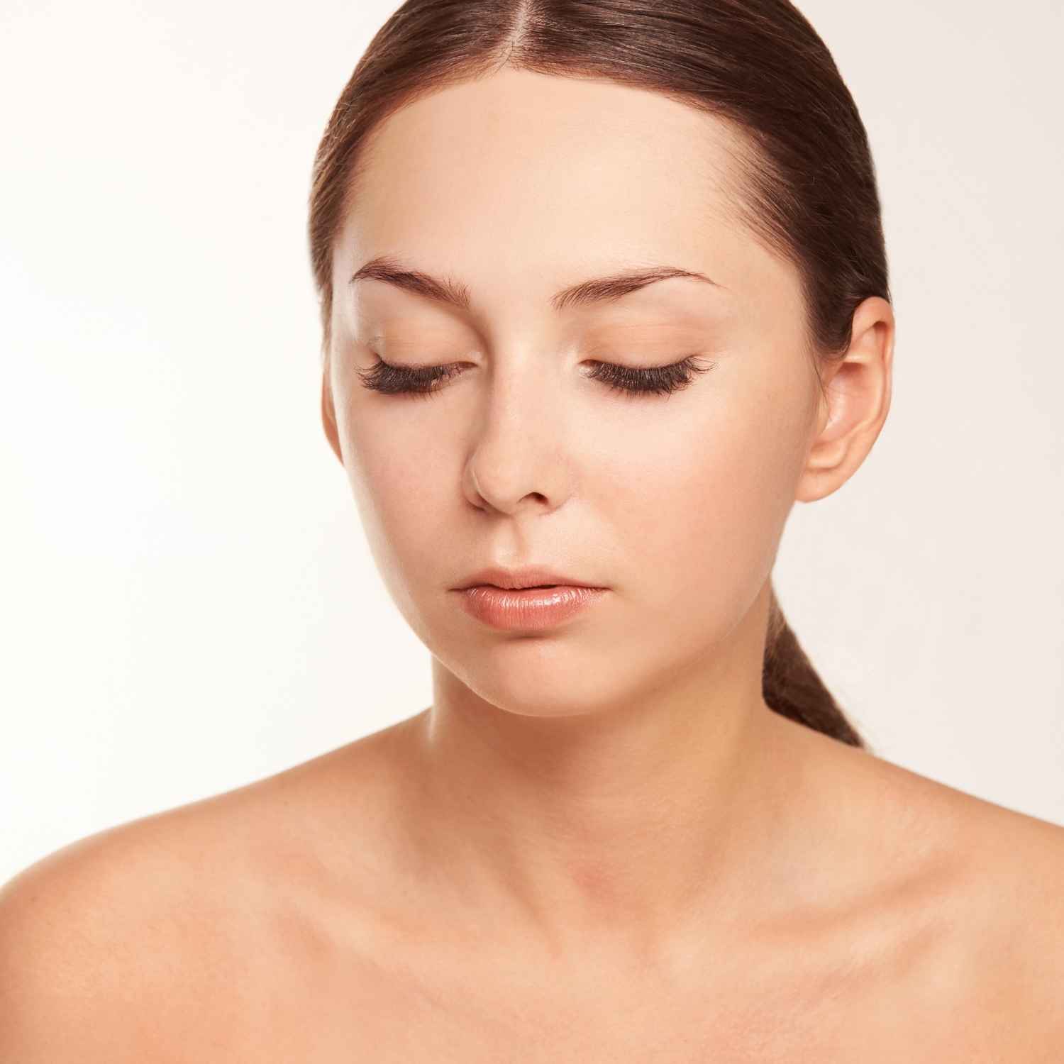 woman receiving a beauty treatment on her face.